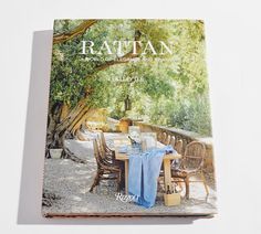 the cover of rattan magazine with an outdoor dining table and chairs set up on it