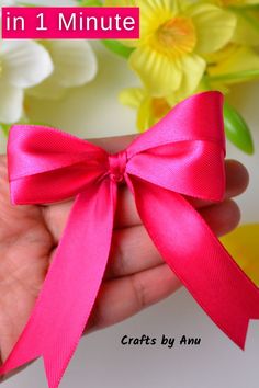 a hand holding a pink ribbon in front of flowers with the text, how to make a bow in 1 minute