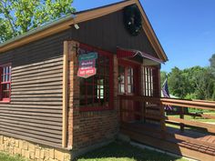 a small wooden building with a sign on it