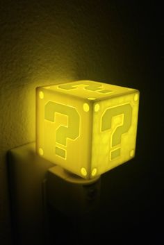 a glowing light cube with question marks on it