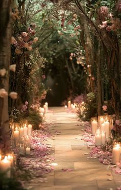 a pathway with many lit candles and flowers