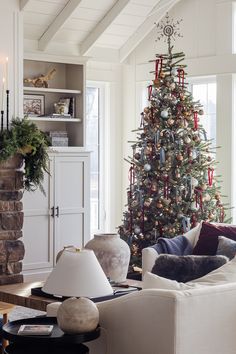 a living room with a christmas tree in the corner