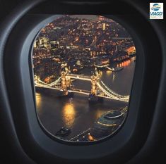 an airplane window looking out at the london bridge and river thames in england, taken from above