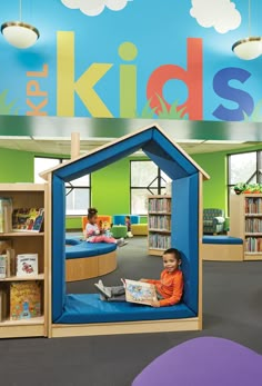 a child's play area in a children's library with bookshelves