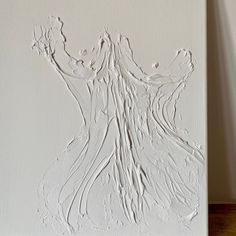 a painting with white paint on the wall