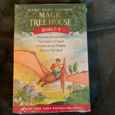 the magic tree house book is being held up by someone's hand in a store