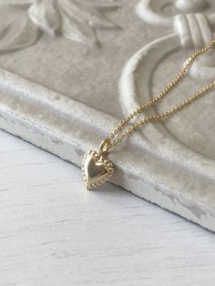 Gold Heart Necklace, Tiny Simple Heart Pendant, Delicate Gold Love Charm, Minimalist Gift for Girlfriend, Valentine's Day gift for women This dainty and delicate necklace features a tiny gold filled heart with dotted edges. The small heart pendant is suspended from a gold filled cable chain. This is a perfect layering necklace, simple and classic, you can wear this casually or dress it up. Ideal to give as a Valentine's Day Gift of an Anniversary gift for girlfriend of wife. About This Necklace Feminine Gold Heart Necklace Gift, Heart Shape Charm Necklace For Valentine's Day, Heart-shaped Charm Necklace For Valentine's Day, Dainty Heart Necklace For Valentine's Anniversary, Feminine Heart Necklace As A Valentine's Day Gift, Feminine Heart Necklace For Valentine's Day Gift, Feminine Heart Charm Necklace For Wedding, Feminine Heart Necklace With Heart Charm, Dainty Heart Detail Charm Necklace