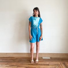 "This is a blue tropical romper from the late 70s early 80s. It features a contrasting light blue fabric at the bust, a waist tie, and a breezy material. \"Island Contrast\" label tag Fits XS-S Bust 30-33\" Waist 20-31\" Hip 45\" Length 36\" Cotton polyester blend Excellent condition" Blue Relaxed Fit Jumpsuits And Rompers For Beach, Light Blue Summer Vacation Jumpsuits, Light Blue Summer Jumpsuits And Rompers For Beach, Blue Summer Jumpsuits With Elastic Waistband, Blue Summer Jumpsuits And Rompers With Elastic Waistband, Blue Summer Jumpsuit With Elastic Waistband, Light Blue Summer Jumpsuits And Rompers, Blue Jumpsuits And Rompers With Elastic Waistband For Vacation, Blue Jumpsuit With Elastic Waistband For Vacation