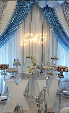 a white table topped with a cake and lots of desserts