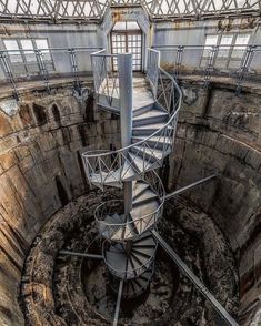 a spiral staircase in the middle of an abandoned building