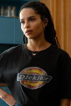 a woman wearing a dickie's t - shirt standing with her hands on her hips