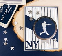 a card with a baseball player on it next to some other cards and paper cutters