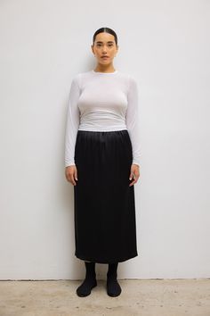 Cut in our silky smooth Barb Satin, The Barb Midi Skirt is a classic, mid-length column silhouette. Featuring a comfortable elastic waistband that can be worn high or low on the waist or hips. 75% Tri-Acetate, 25% Polyester Dry clean only Made in Los Angeles, CA. Fabric made in Japan. Model 5’8” – Wearing Size L Length: 32 1/2” Waistband: 25” Satin Set, Heel Accessories, Japan Model, Fabric Shoes, Black Midi Skirt, Classic Dress, Silhouette Cut, Sweater And Shorts, Skirt Outfits