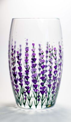 a glass with purple flowers painted on it