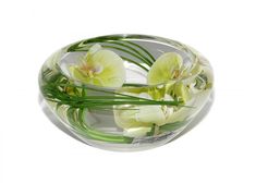 there is a glass bowl with flowers in it