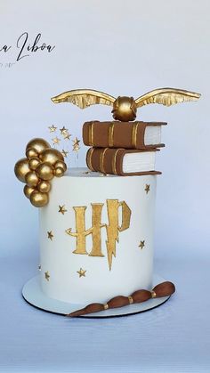 a cake decorated with books and gold decorations