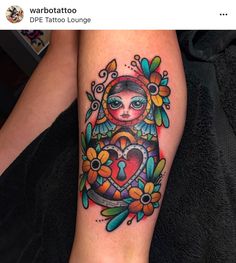 a woman's leg with a colorful tattoo on it