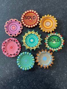 six colorful ceramic dishes with the word god on them, all decorated in different colors