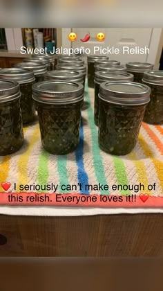 six jars of pickles sitting on top of a colorful table cloth with the words sweet jalapeno pickle relish