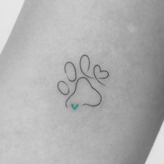 a dog paw tattoo on the left side of the leg, with a heart in the middle