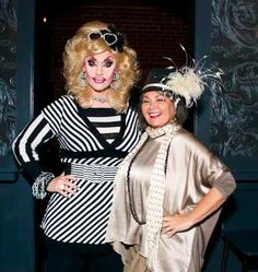 two women dressed in costumes posing for the camera