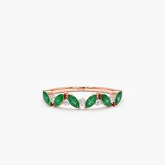 a rose gold ring with green leaves and diamonds