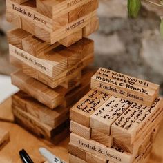 a stack of wooden blocks sitting on top of a table next to a pen and marker