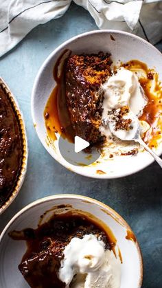 three bowls filled with dessert and ice cream on top of a blue tablecloth,