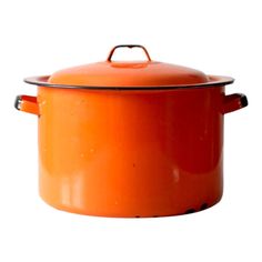 an orange casserole is sitting on a white surface with a black handle and lid