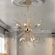 a chandelier hanging from the ceiling in a living room