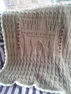 a crocheted blanket with a castle on it