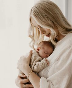 a woman holding a baby in her arms