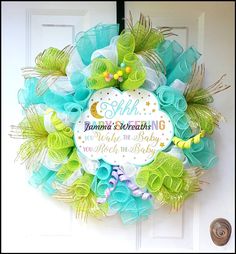 a wreath that is hanging on the front door with an inscription saying, happy birthday