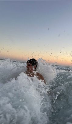 a man riding a surfboard on top of a wave in the ocean