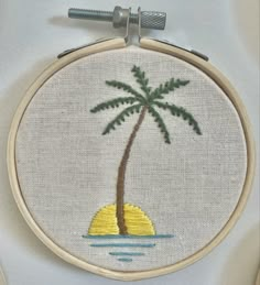 a small palm tree is in the middle of an embroidery pattern on a white background