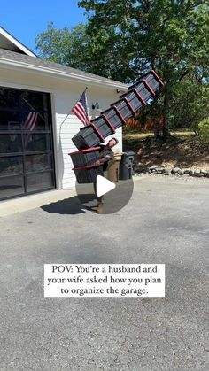 an american flag hanging from the side of a garage door with a message written on it