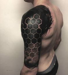 a man's arm with black and white honeycombs tattoo on his left shoulder