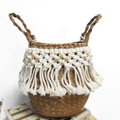 a woven basket sitting on top of a stack of books