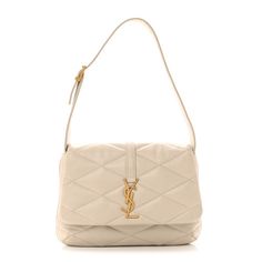 This is an authentic SAINT LAURENT Lambskin Quilted Le 57 Diamond Shoulder Bag in Crema Soft. This elegant shoulder bag is crafted of quilted lambskin leather. The bag features aged gold hardware, diamond quilting, adjustable leather shoulder strap, and a YSL emblem on the front flap. The flap opens to a suede interior with a flat pocket. Lambskin Leather, What I Want, Ysl Bag, Gold Hardware, The Bag, Saint Laurent, Quilting, Shoulder Strap, I Want