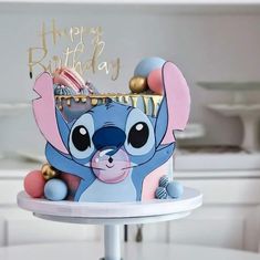 a birthday cake with an image of stitch on it