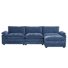 a blue sectional couch sitting on top of a white floor