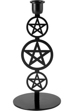 a black candle holder with three pentagrams on it and an inverted star in the center