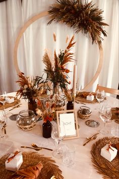 a table set up with place settings and flowers