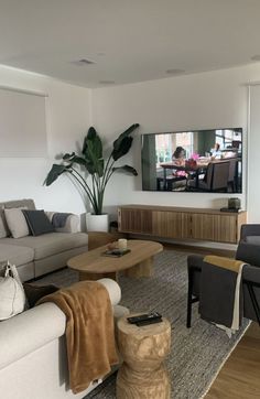 a living room filled with furniture and a flat screen tv mounted to the side of a wall