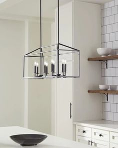 a chandelier hanging from the ceiling in a kitchen