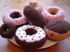 there are knitted donuts on the plate