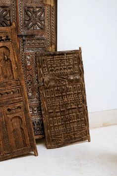 three carved wooden doors sitting next to each other