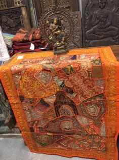 an orange cloth covered box sitting on top of a table