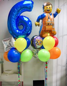 balloons are arranged in the shape of an astronaut and number six