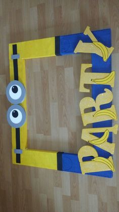 a cardboard cut out of the shape of a minion with two eyes and one eye